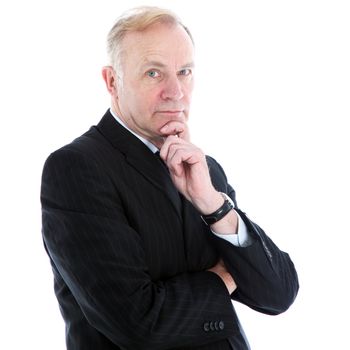 Pensive thoughtful middle-aged businessman with a serious expression standing looking at the camera with his chin resting on his hand 