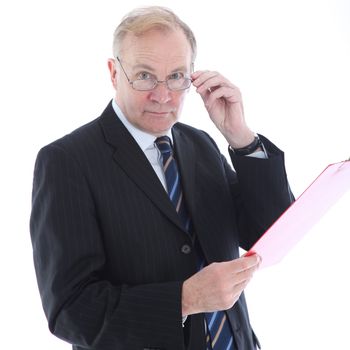 Middle-aged businessman peering over the top of his glasses with an assessing look 
