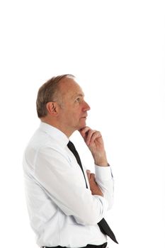 Businessman standing in profile with his chin resting on his hand in deep contemplation Businessman standing in profile with his chind resting on his hand in deep contemplation 