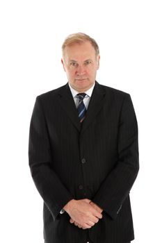 Middle-aged buisnessman standing facing the camera with his hands folded in front of him isolated on white 