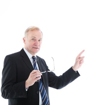 Motivated middle-aged businessman holding glasses in one hand and pointing with the other to blank white copyspace 