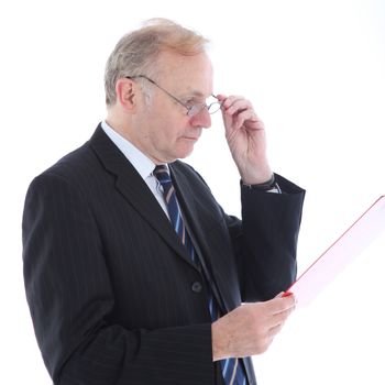 Serious middle-aged businessman wearing glasses reading a report he is handholding isolated on white 