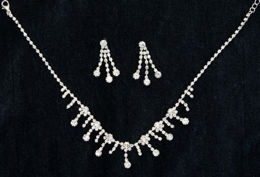 Necklace with sparkling stones on dark fabric