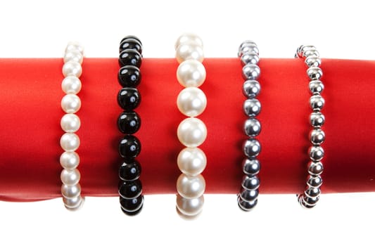 Women's bracelets on the red hat on a white background