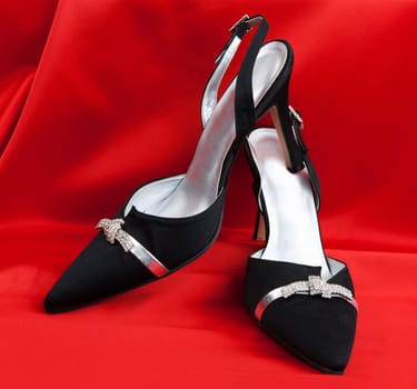 Pair of black women's shoes on a white background