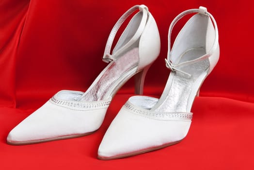 Pair of white women's shoes on a white background