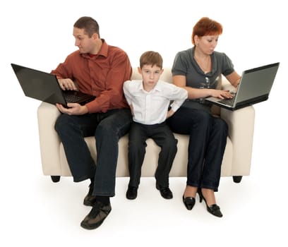 dad mom and son with laptop sitting on the couch