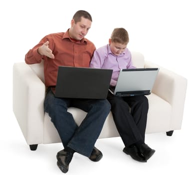 Father and son sitting on the couch with laptops