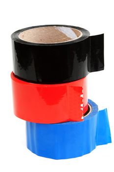 Three rolls of color tape blue, red and black