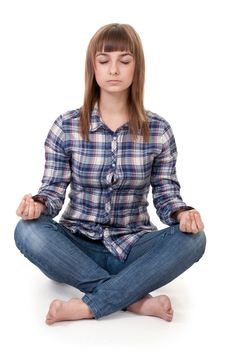 Beautiful girl in a plaid shirt sitting in the lotus position