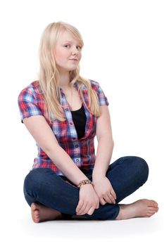 Beautiful girl in a plaid shirt sitting in the lotus position