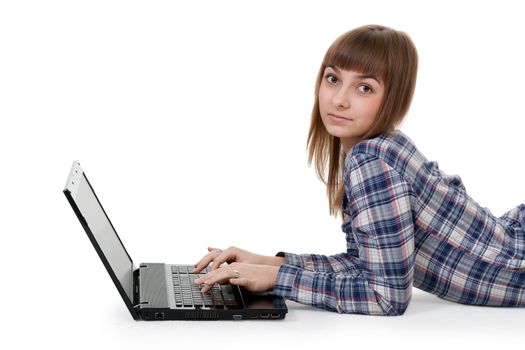beautiful young girl lying on the floor with laptop