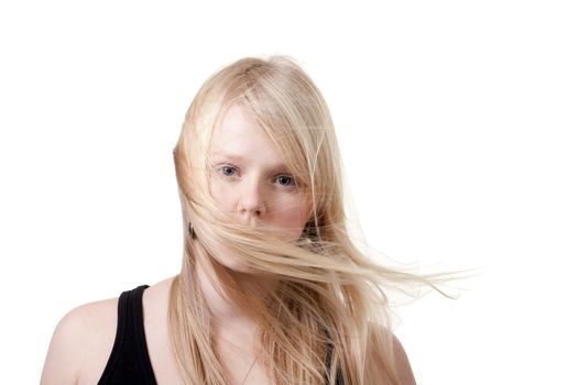 Blond hair is developing the wind on a white background