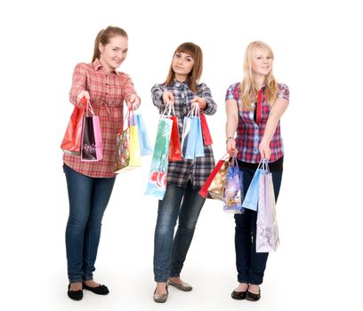 Three girls with colorful shopping bags on white background