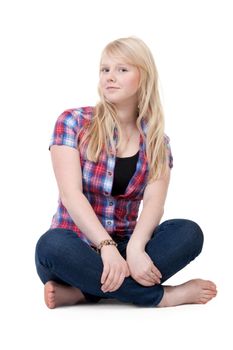 Beautiful girl in a plaid shirt sitting in the lotus position