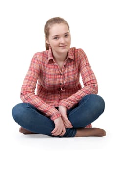 Beautiful girl in a plaid shirt sitting in the lotus position