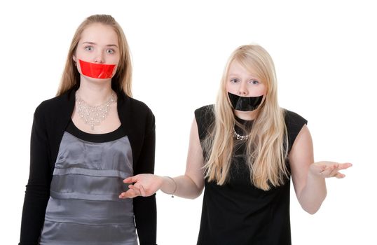 Two beautiful girls with their mouths taped with tape