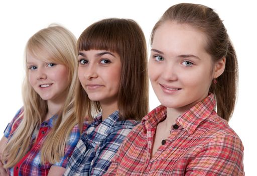 three young beautiful girlfriends on a white background