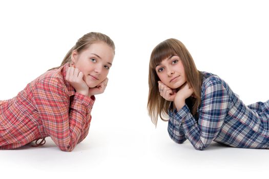 Two young beautiful girls lying on the floor