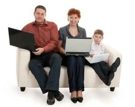 dad mom and son with laptop sitting on the couch