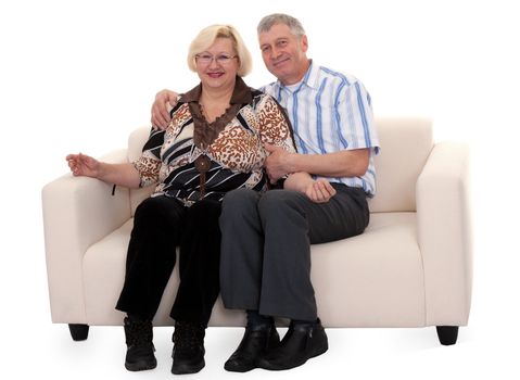 Mature couple sitting on a sofa on a white background