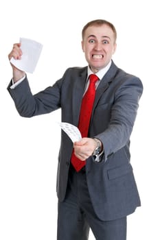 Young businessman in a rage tearing paper