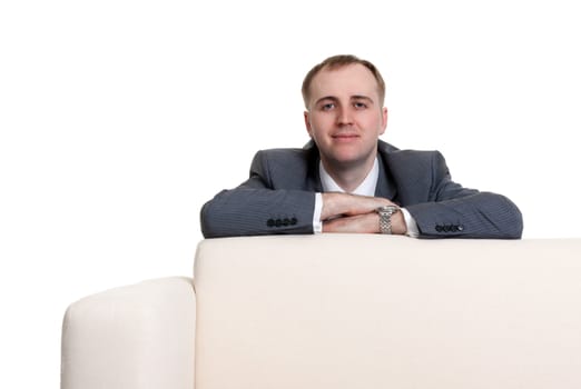 businessman looking out over the sofa on a white background