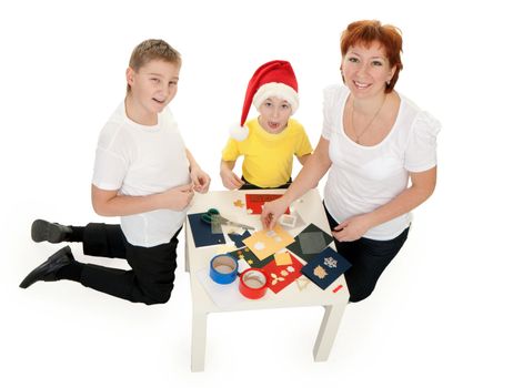 Mother with children involved in scrapbooking table