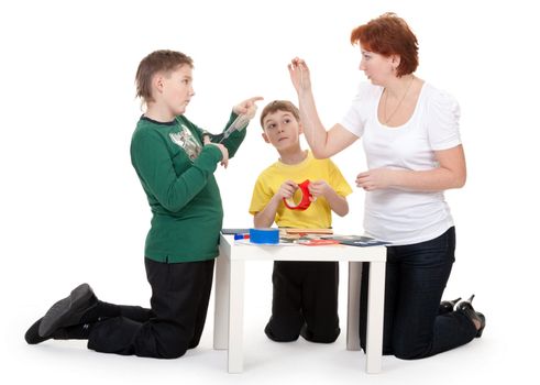 Mother with children involved in scrapbooking table