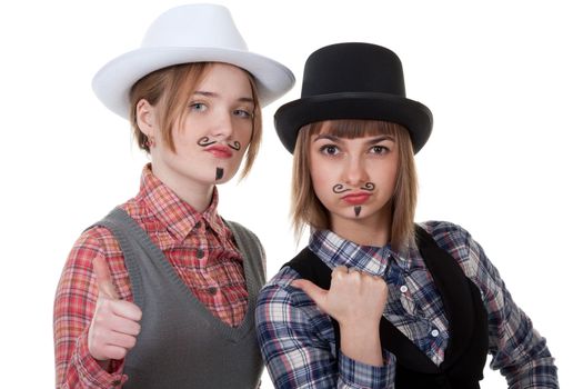 Two girls with painted mustaches and bowler hats on white background