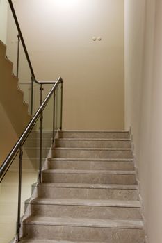 Corridor and the marble staircase with steel handrails