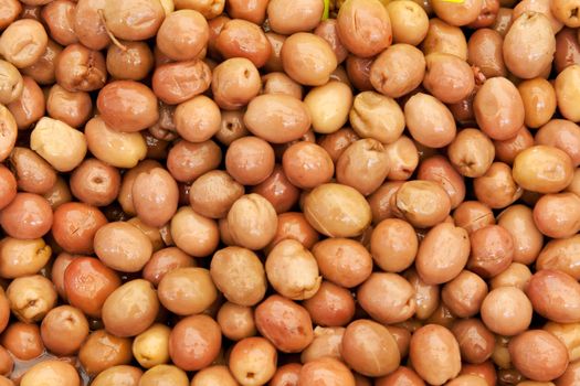Background of ripe marinated olives at the market