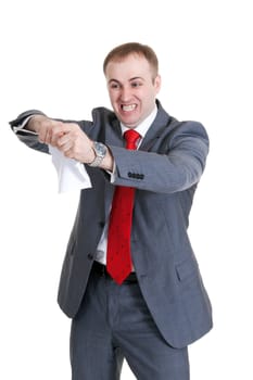 Young businessman in a rage tearing paper