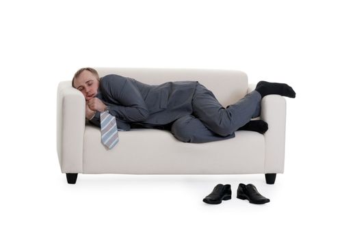 businessman sleeping on a sofa on a white background