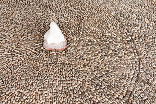 pavement of small stones and a large white crystal