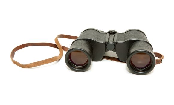 Old black glasses with a leather strap on a white background