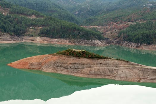 Form an island in the azure mountain lake