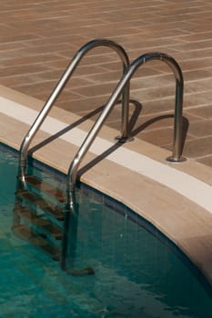 steel staircase from the pool with turquoise water