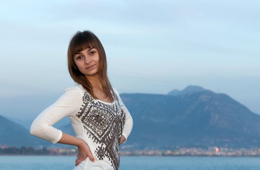 beautiful young girl against the evening sea