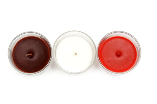 Three glass candlesticks with colour aromatic candle