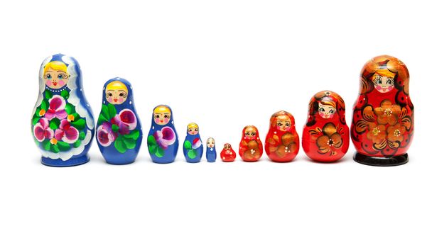 Russian nesting dolls stand in a row on a white background