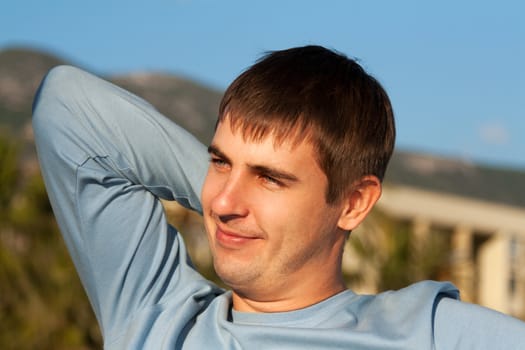 portrait of a man against the backdrop of greenery