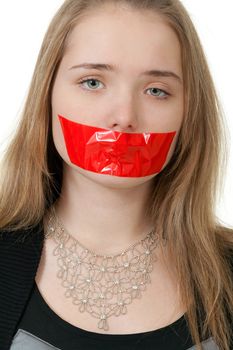 beautiful girl with her mouth sealed with red tape