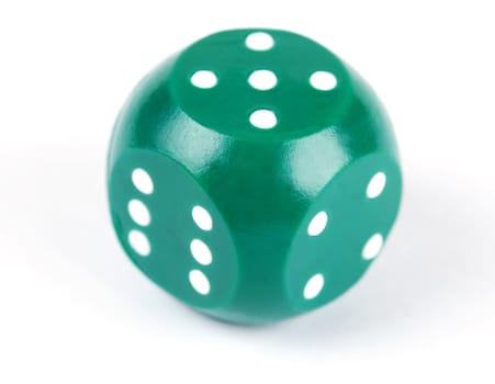 green plastic dice isolated on a white background