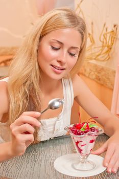 Young woman in the cafe eat dessert