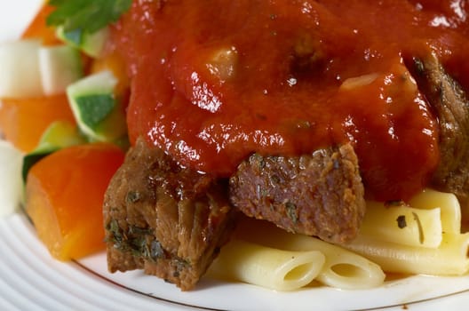  pasta with tomato beef sauce  on wooden table