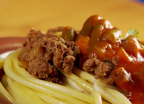  pasta with  beef ,vegetable  tomato sauce  on wooden table