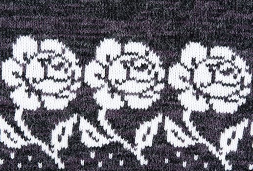 knitted gray background with a pattern in the form of a flower
