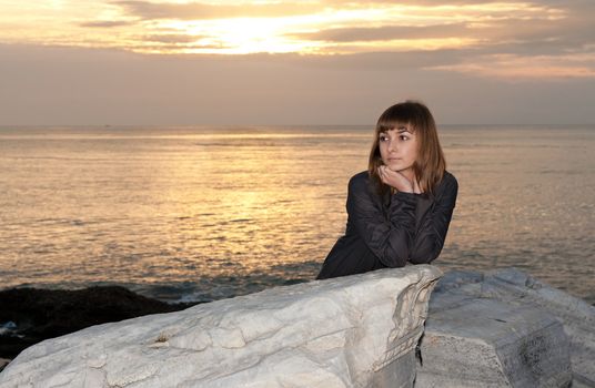girl against the sea at night in Side, Turkey
