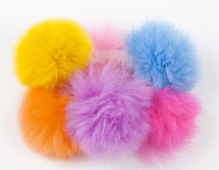 fur hair-slide from the colored balls on a light background